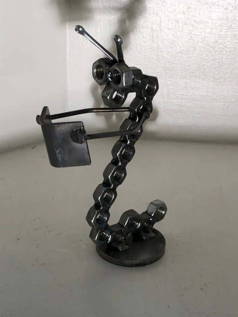 Bookworm made of scrap metal and nuts and bolts